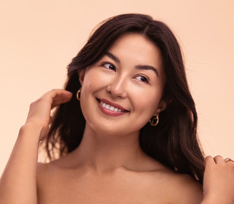 woman moving her hair off her shoulder looking to the right