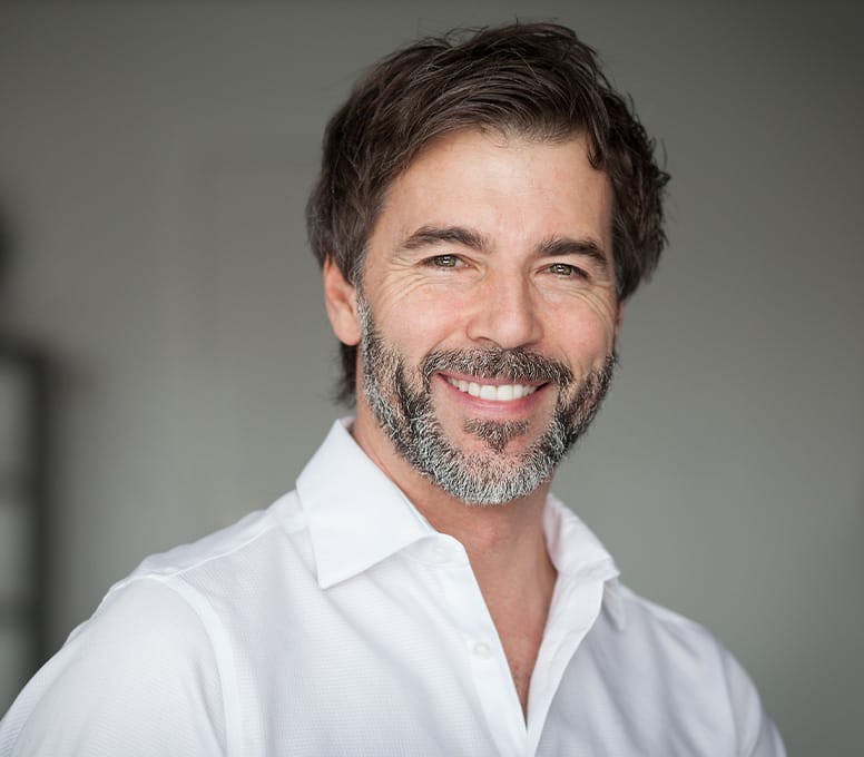 man in white collared shirt smiling