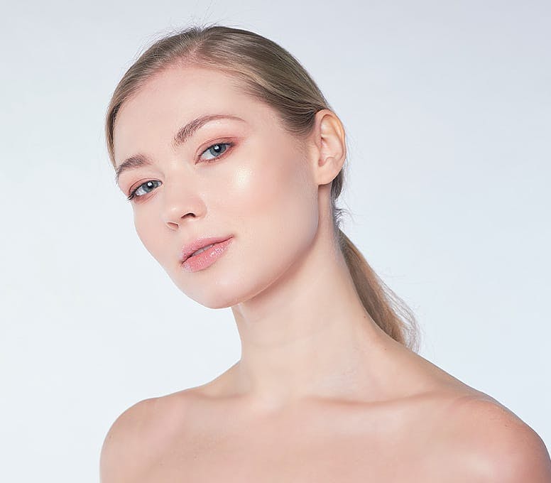 woman leaning her head to the left with a low pony tail