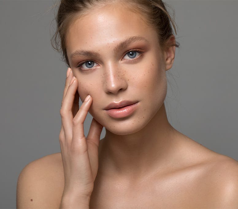 woman resting her hand against her face