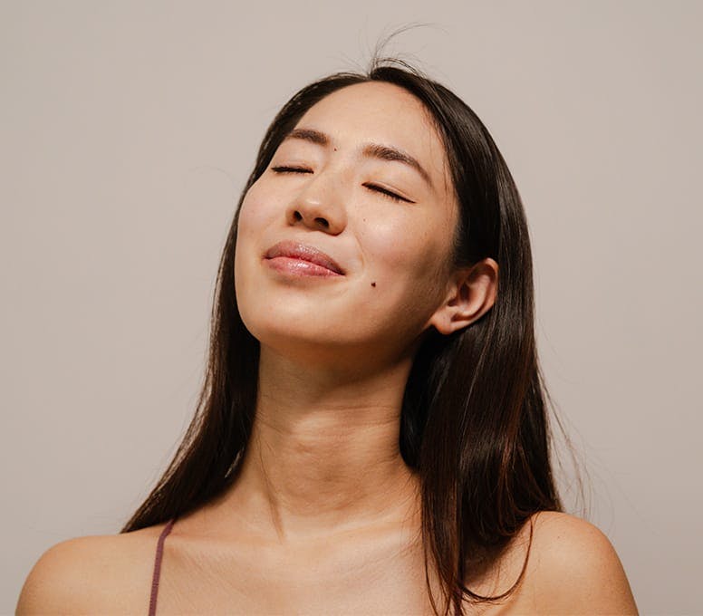 woman tilting her head up with her eyes closed