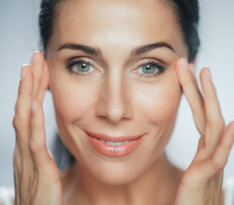woman with hands around her eyes