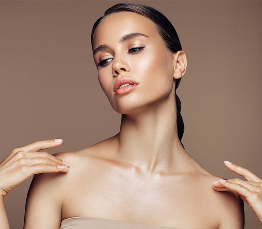 woman touching her shoulders