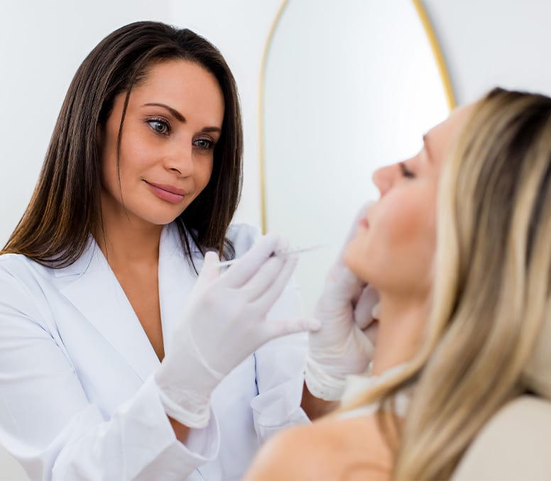 woman injecting into another woman's chin