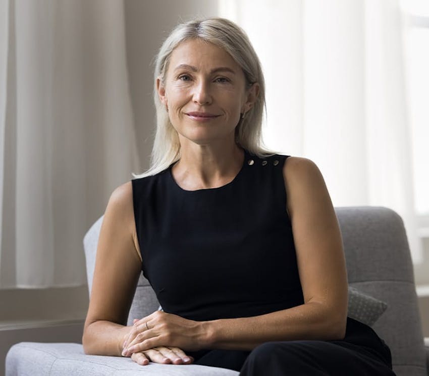 woman in black dress sitting on couch