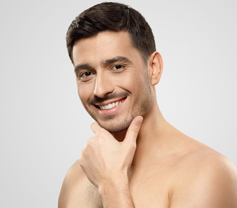 man smiling with hand under his chin