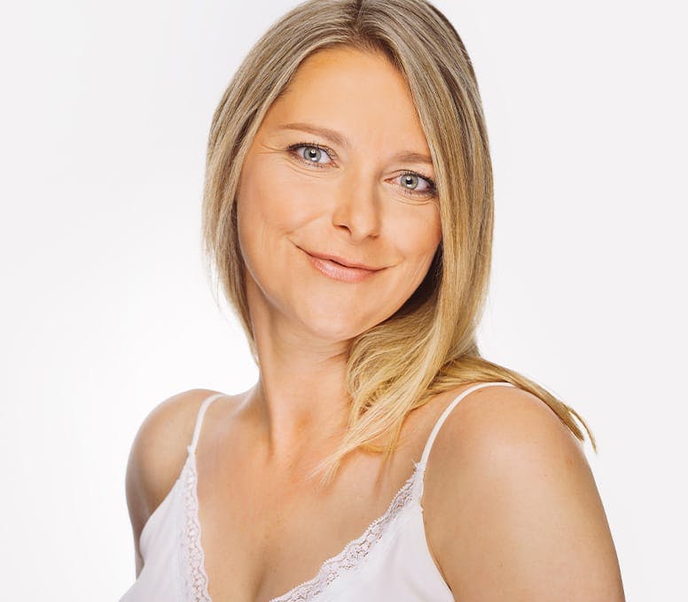 woman in white tank top smiling