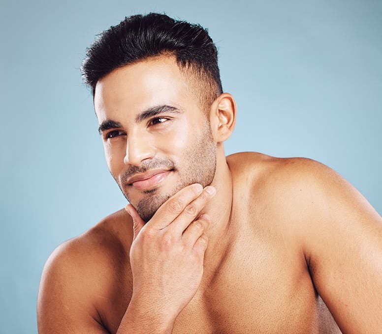 man rubbing his beard
