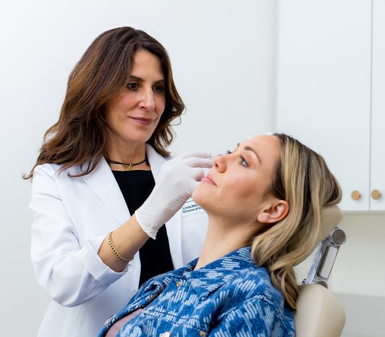 Dr injection dermal fillers into patient
