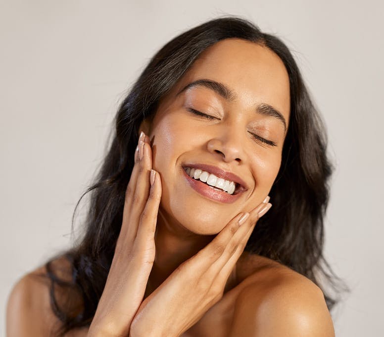woman touching her face with both hands