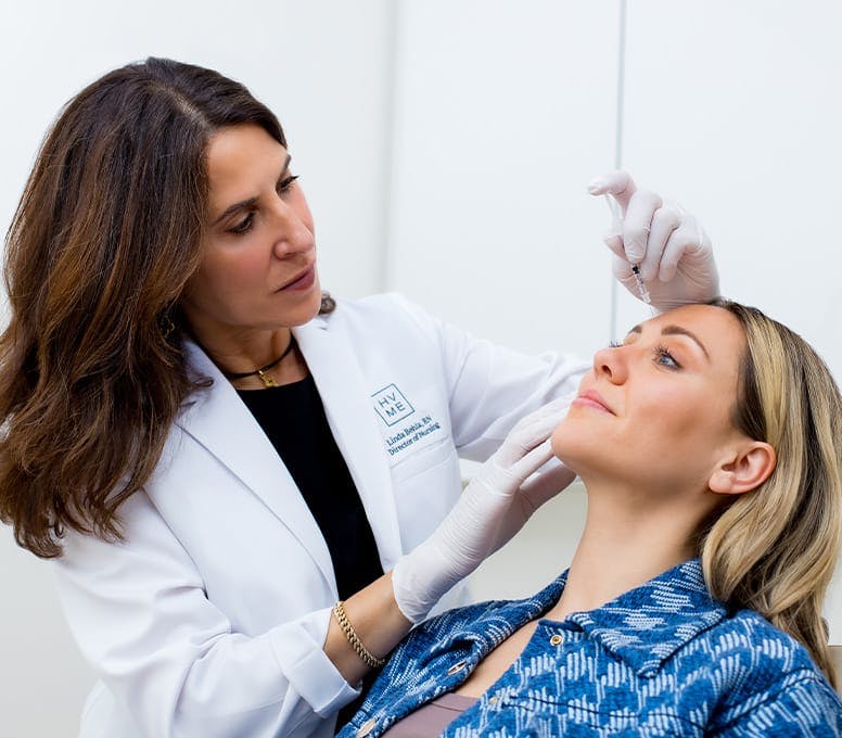 woman getting injection in her forehead