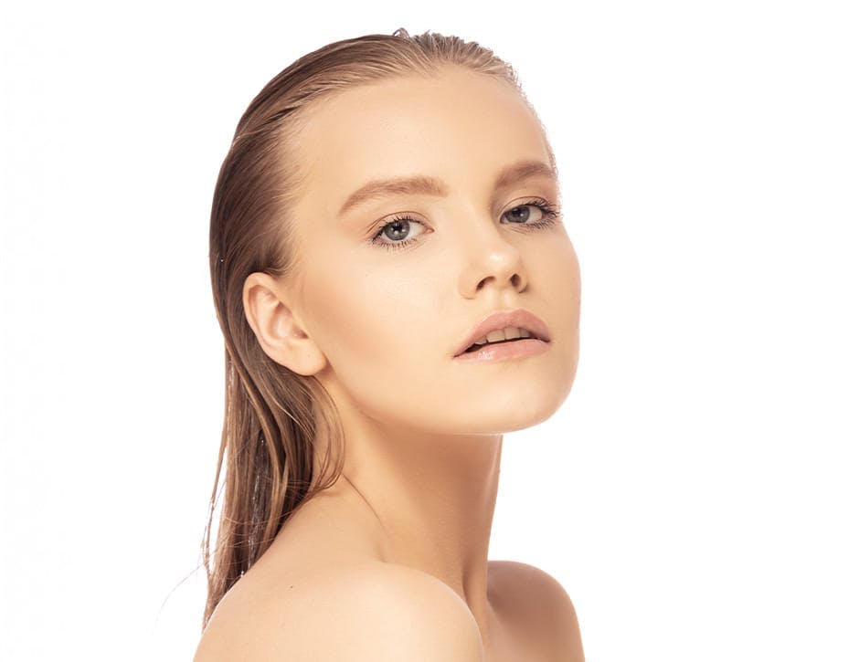 woman with slick back hair looking forward