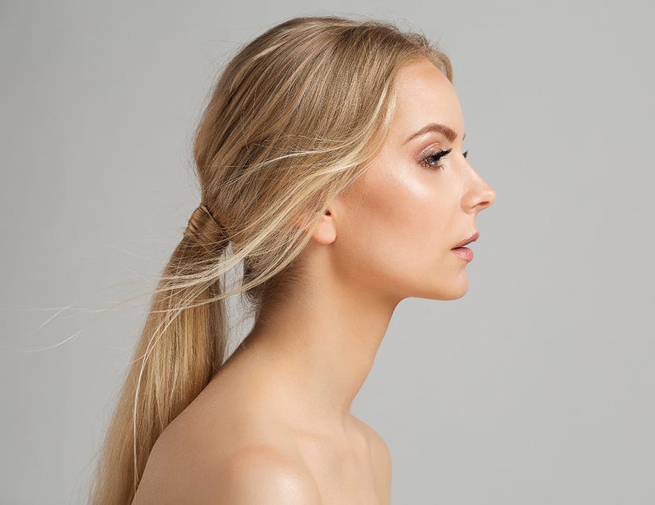 side profile of woman with low ponytail