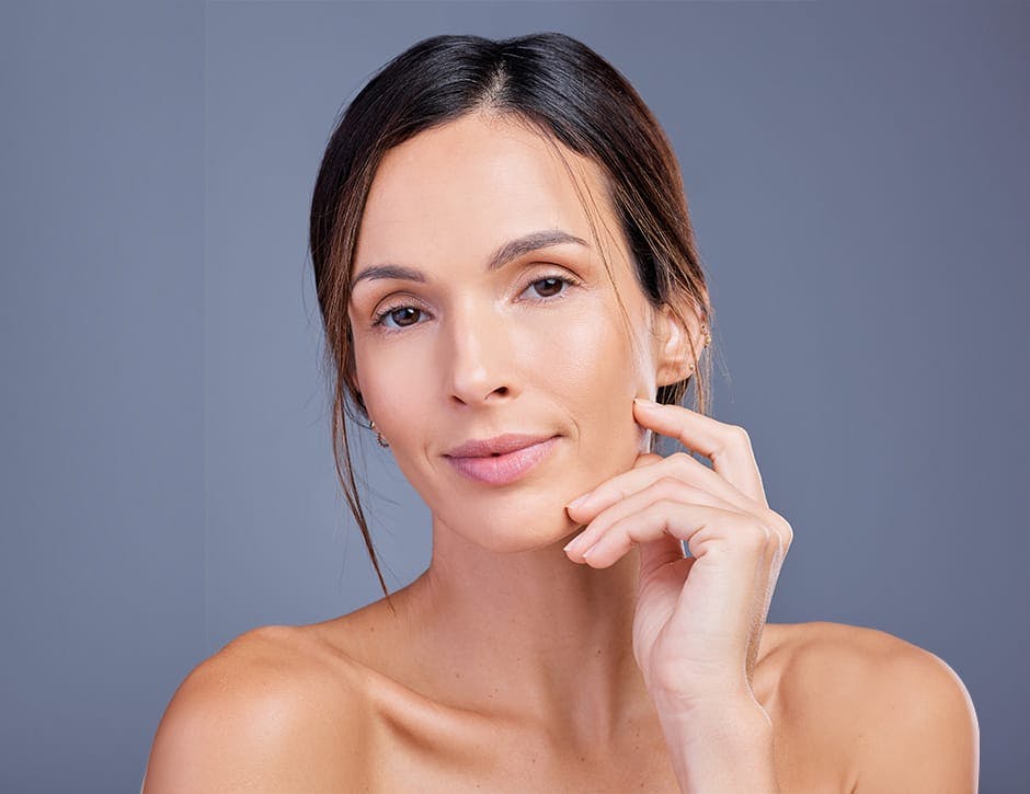 woman with her fingers touching her jaw