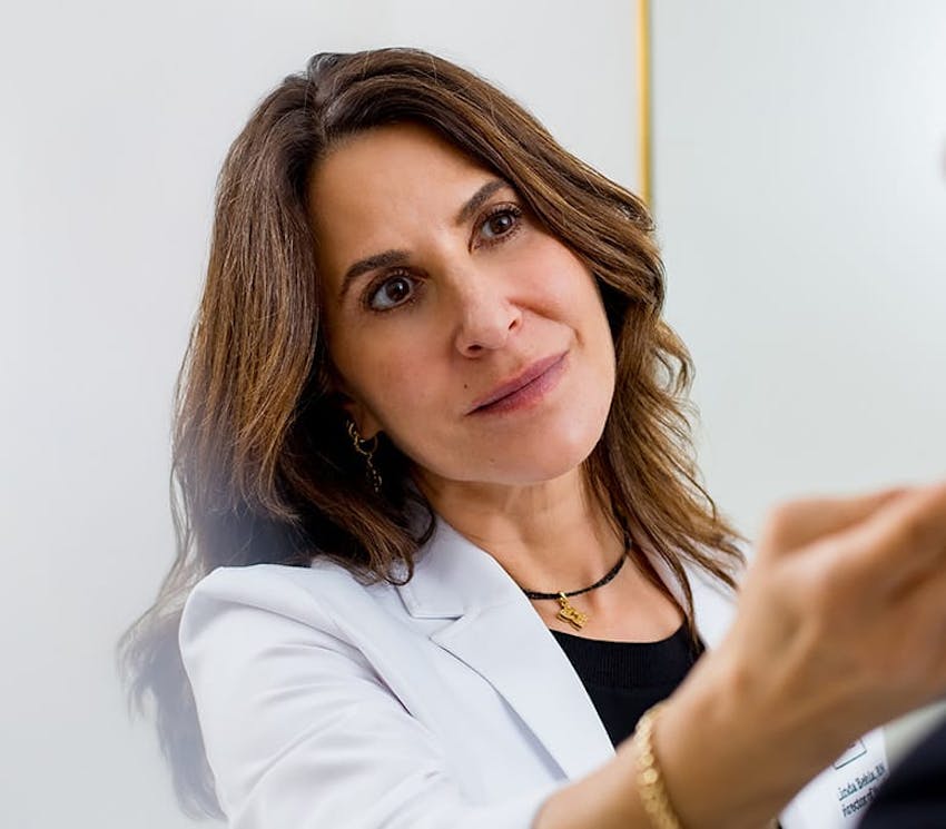 Linda tilting her head looking at patient