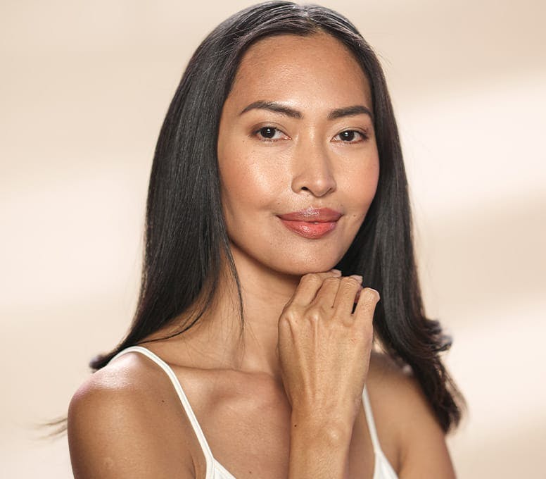 woman with straight hair with hand under her chin
