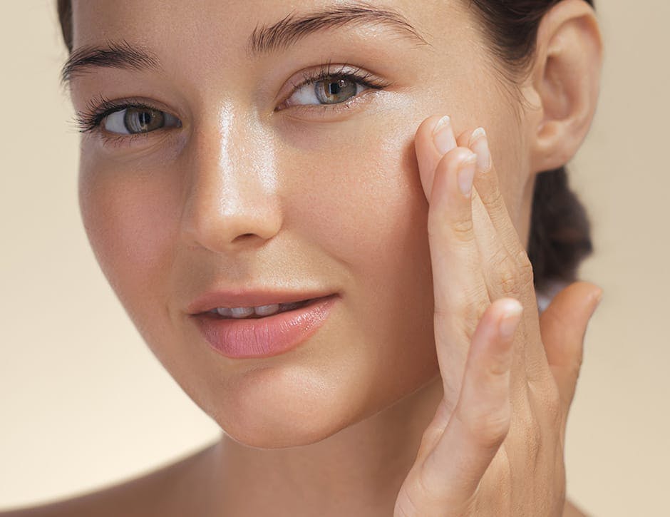 close up of woman touching her cheek