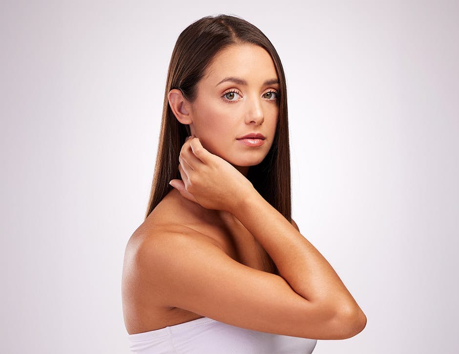 woman touching her neck