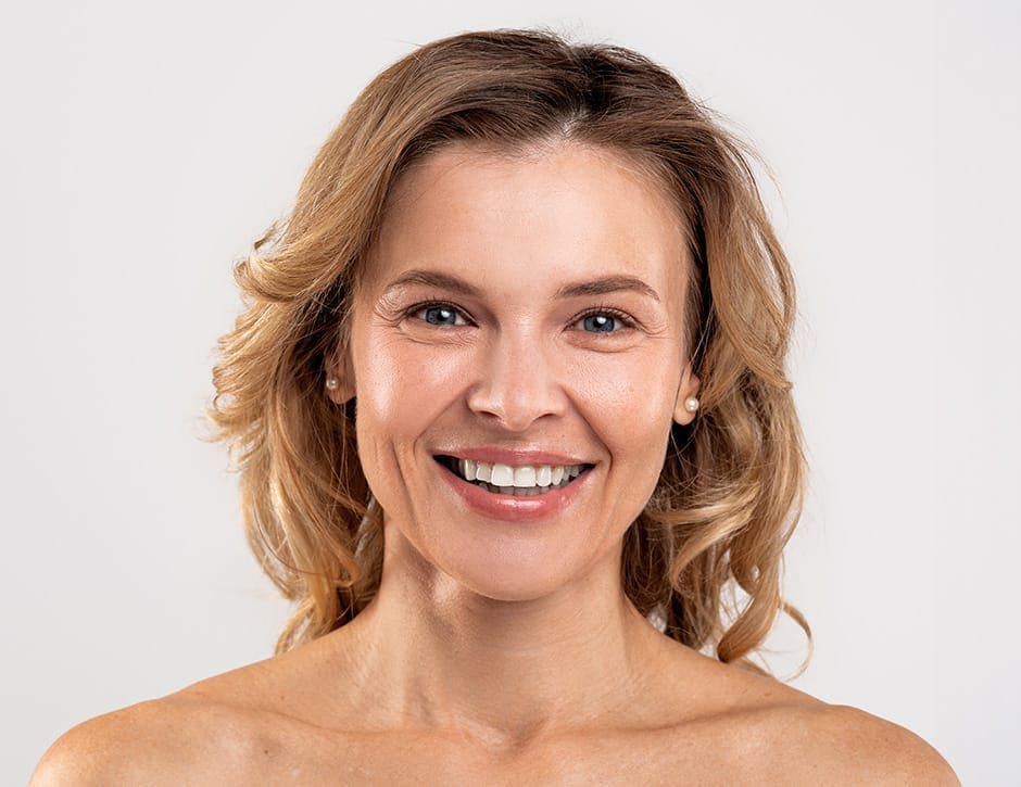 woman facing forward and smiling