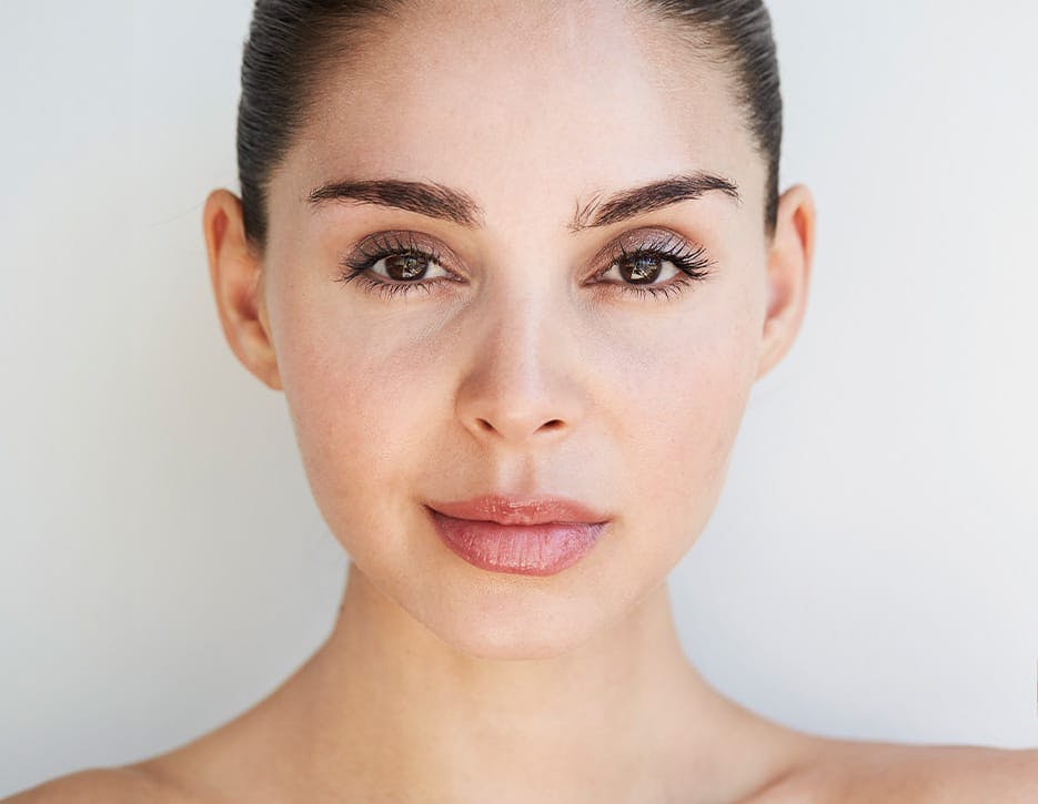 woman looking forward with her hair tied up