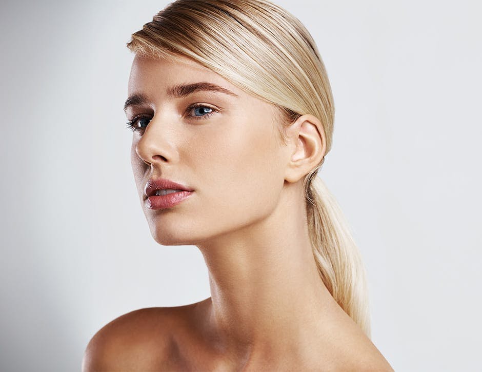 woman with a blonde low ponytail