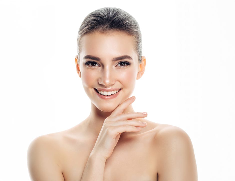 woman with finger under her jaw and smiling