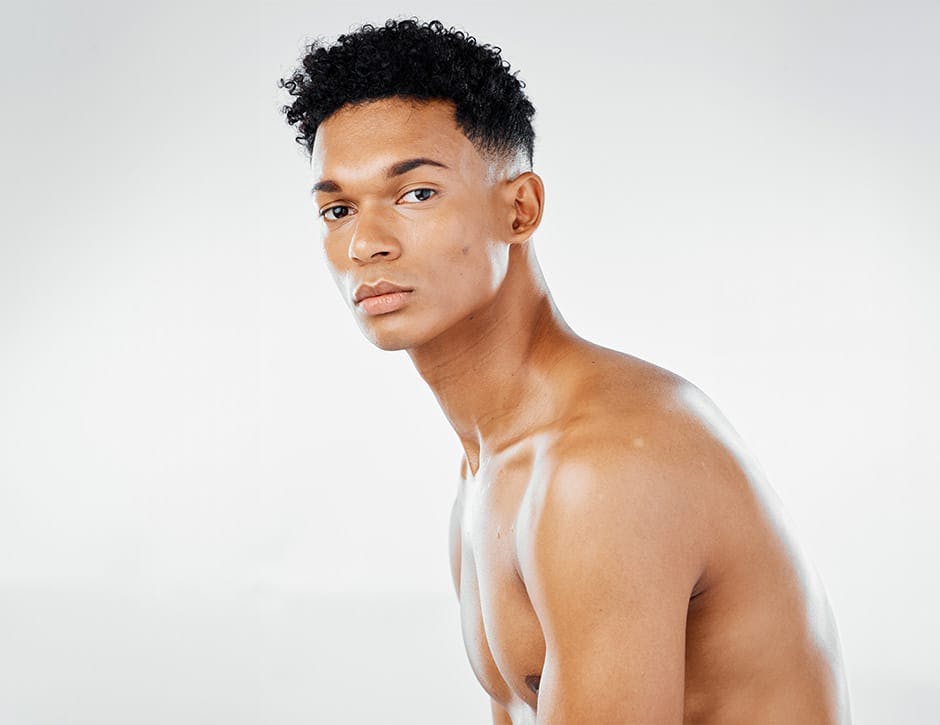 man with curly hair leaning over slightly