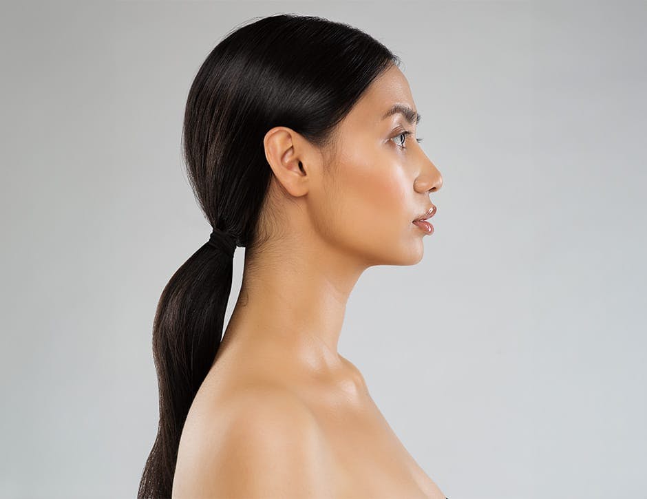 side profile of woman with low ponytail