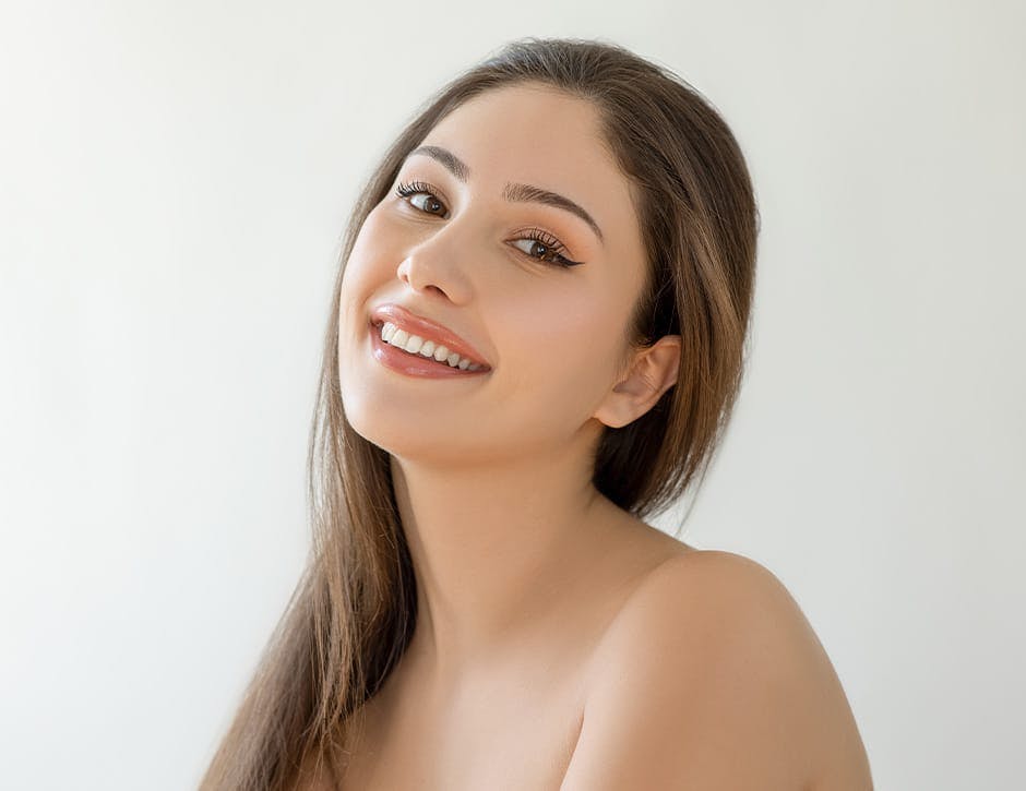woman tilting her head back and smiling