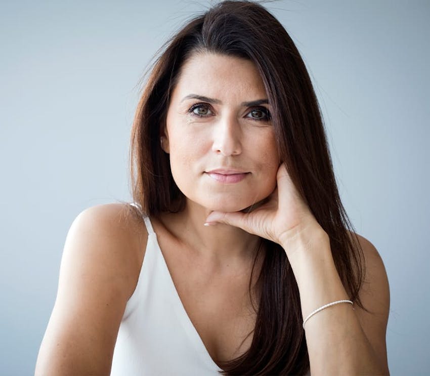 woman with her hand around her jaw and neck