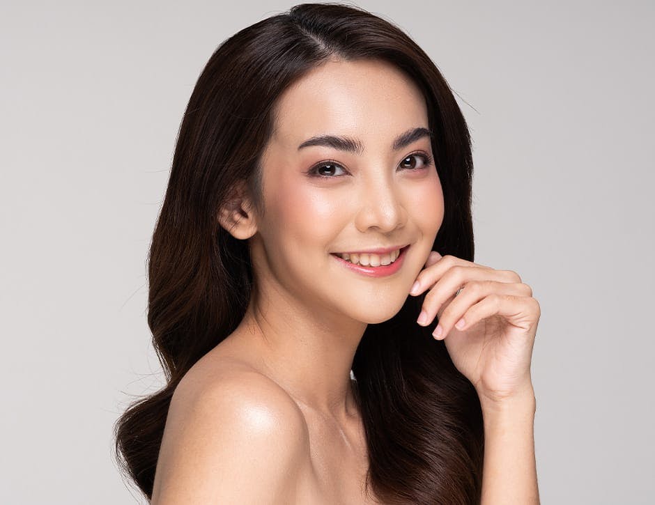 woman facing the right looking forward and smiling