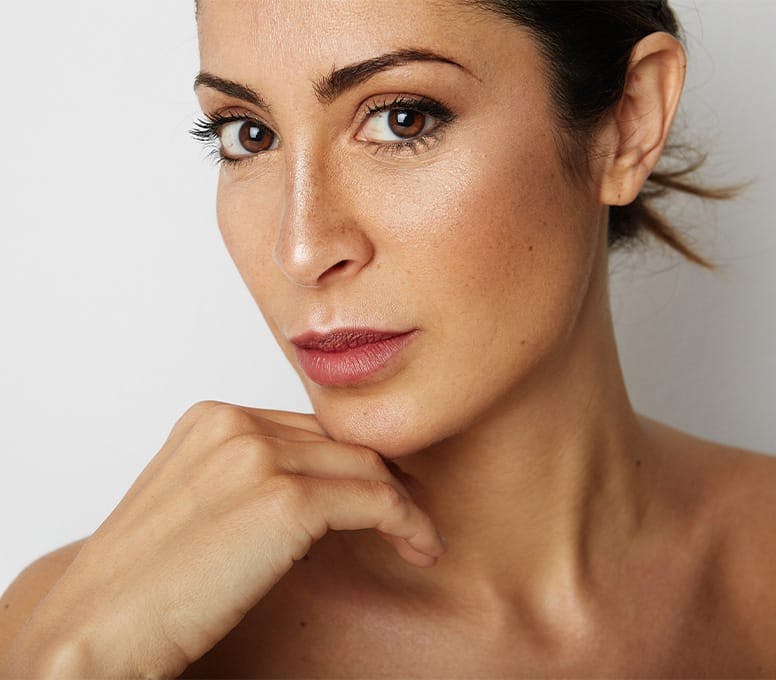 woman with her chin on her knuckle