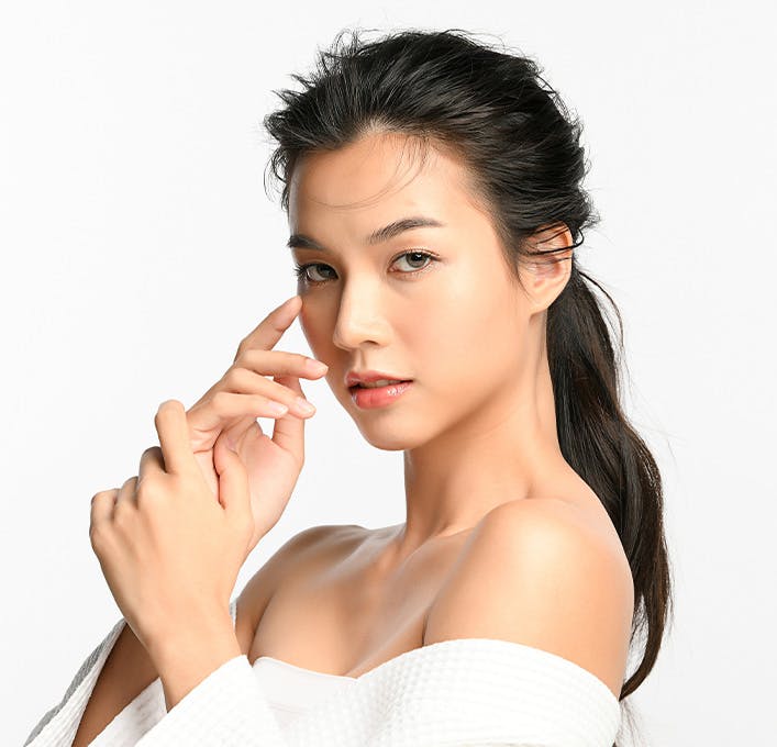 woman with q-tip near her cheek