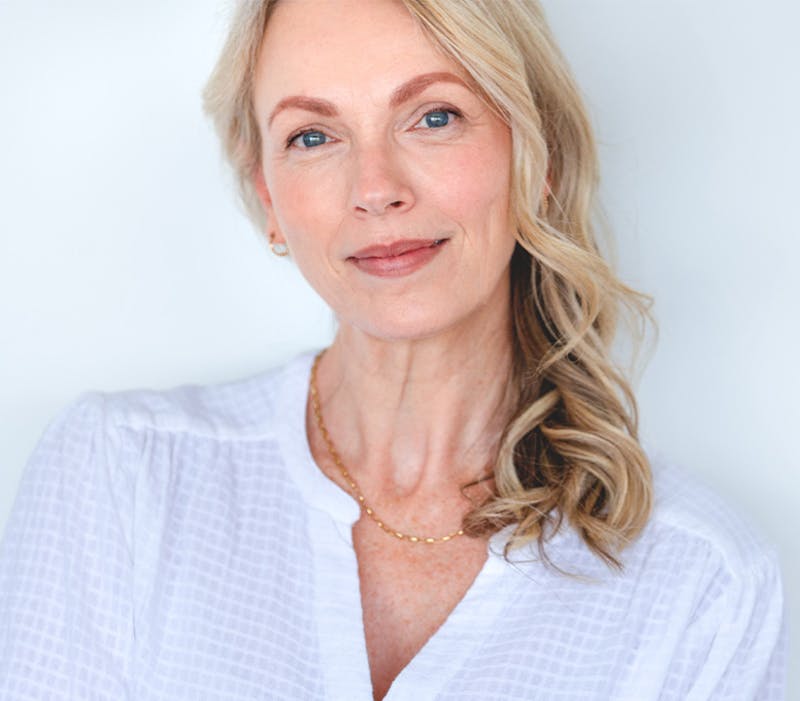 Smiling woman in white top