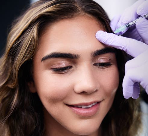 Patient at Westside Plastic Surgery getting a forehead injection