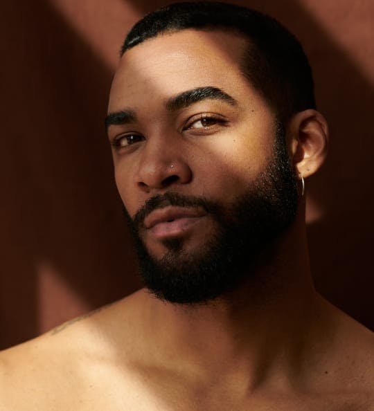 Man’s face mostly covered by shadow