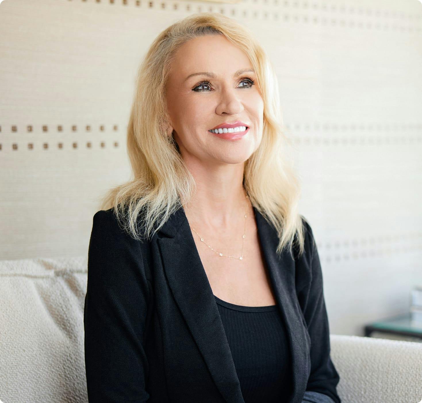 Woman sitting on a couch, smiling