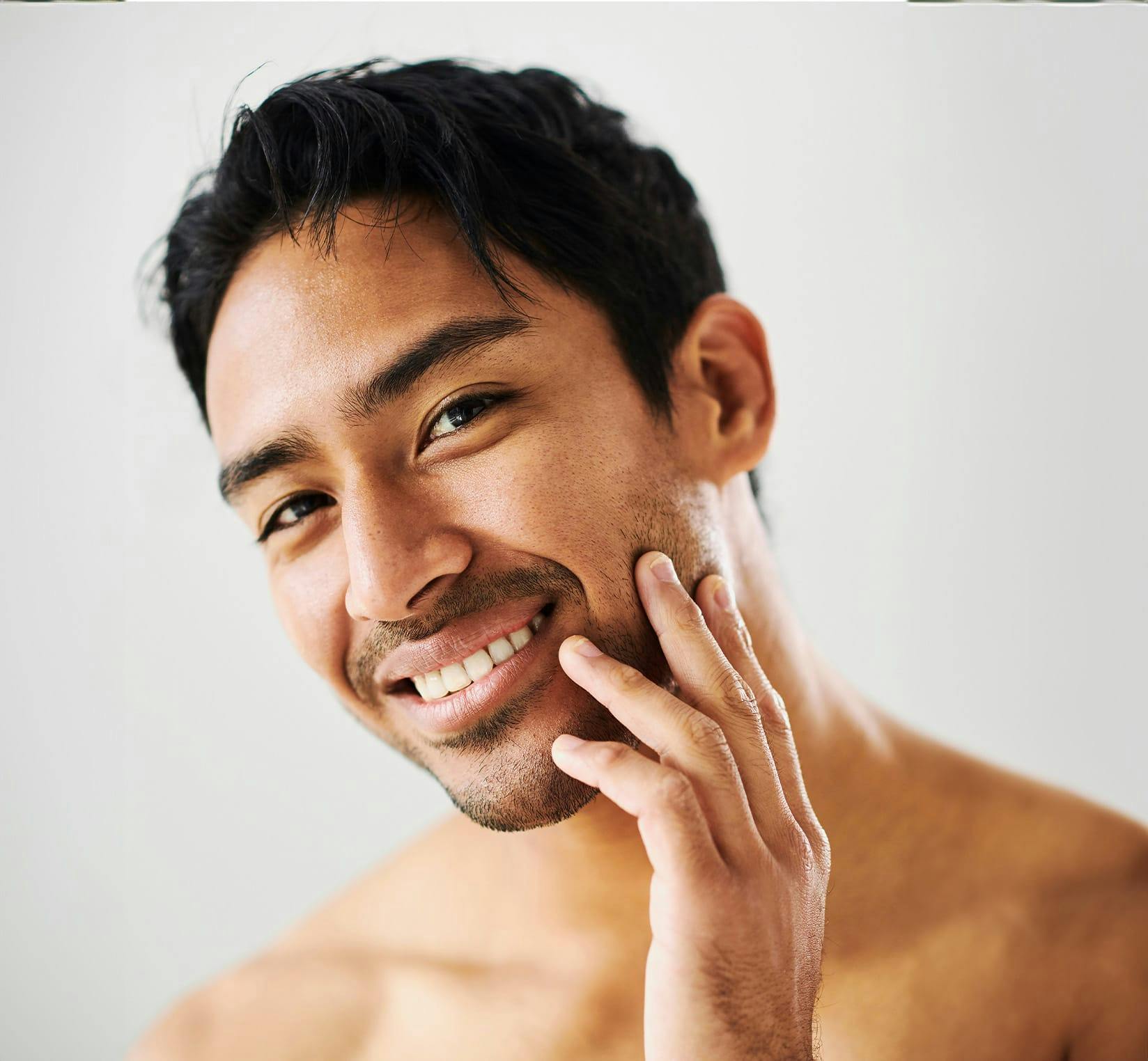 Man running fingers over stubble