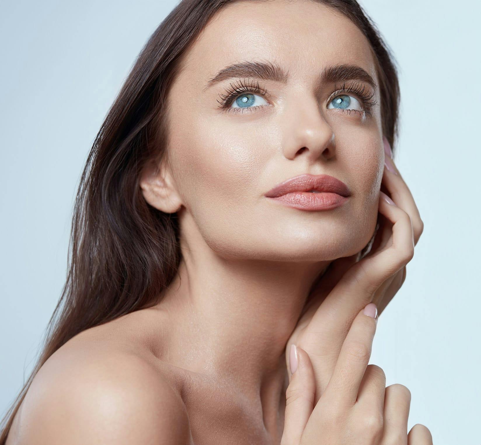 Woman holding cheek in hand