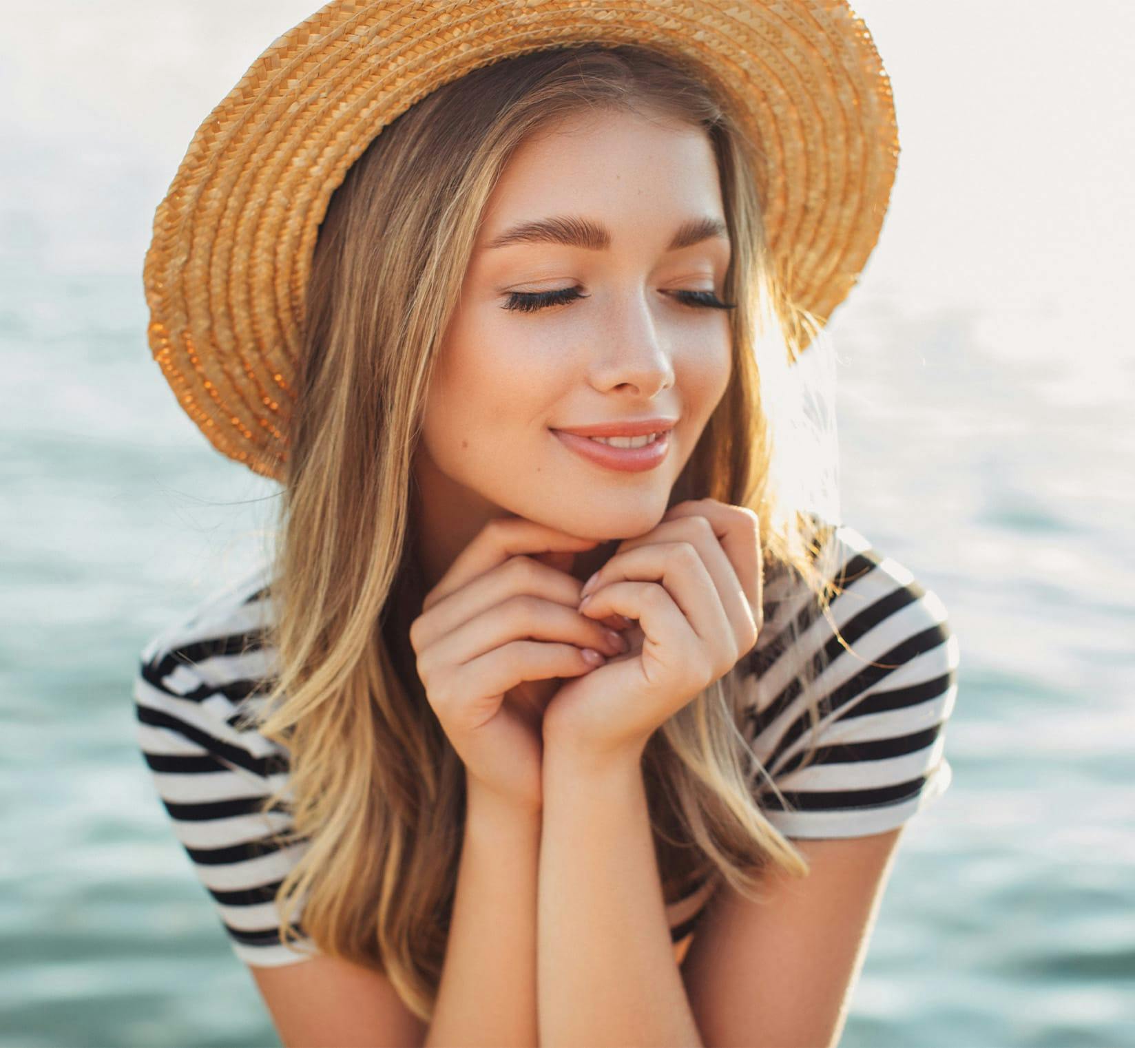 Woman smiling and wearing sunhat