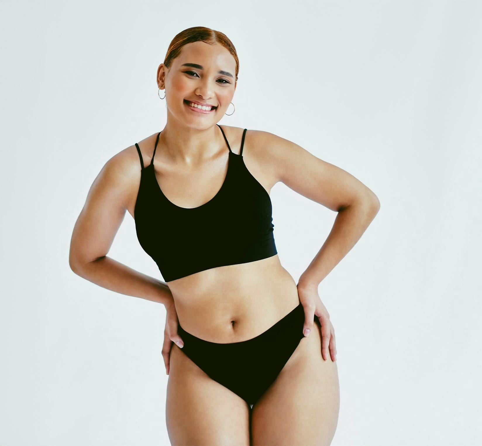 Woman posing in black undergarments