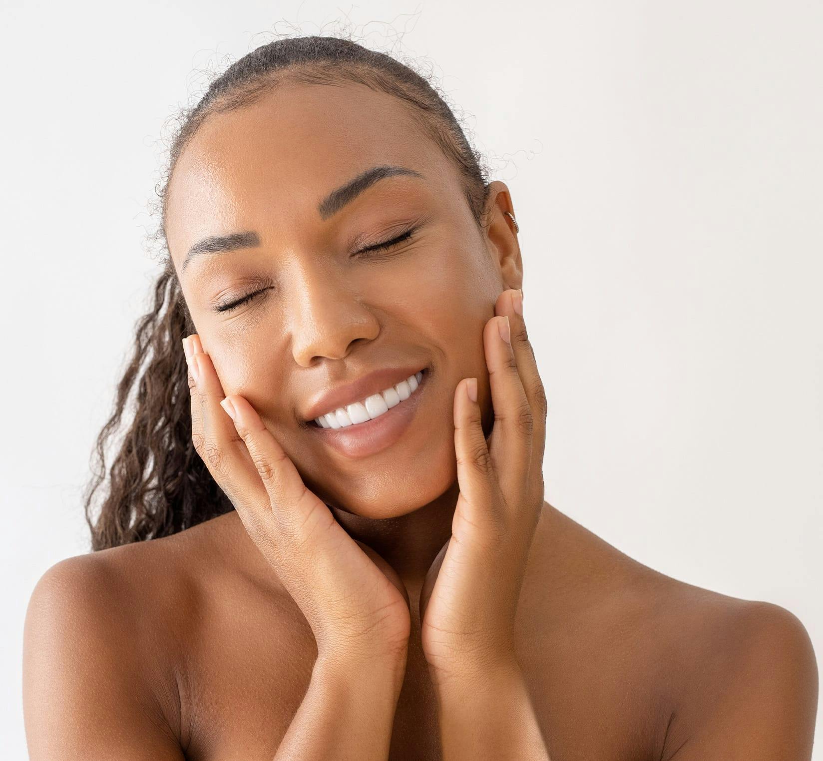 Woman smiling and holding chin