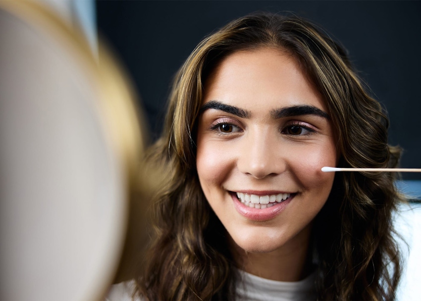 Woman looking in mirror and smiling