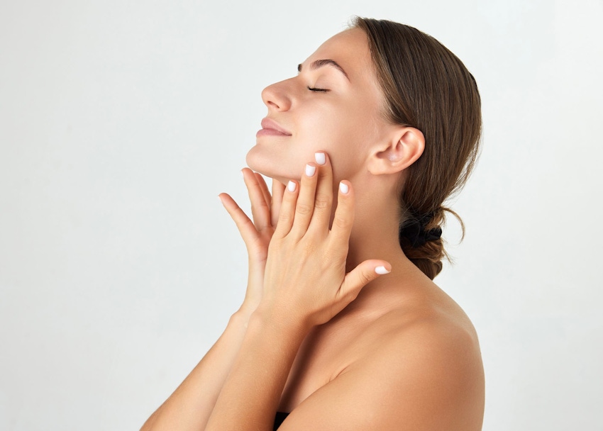 Woman smiling and holding cheeks