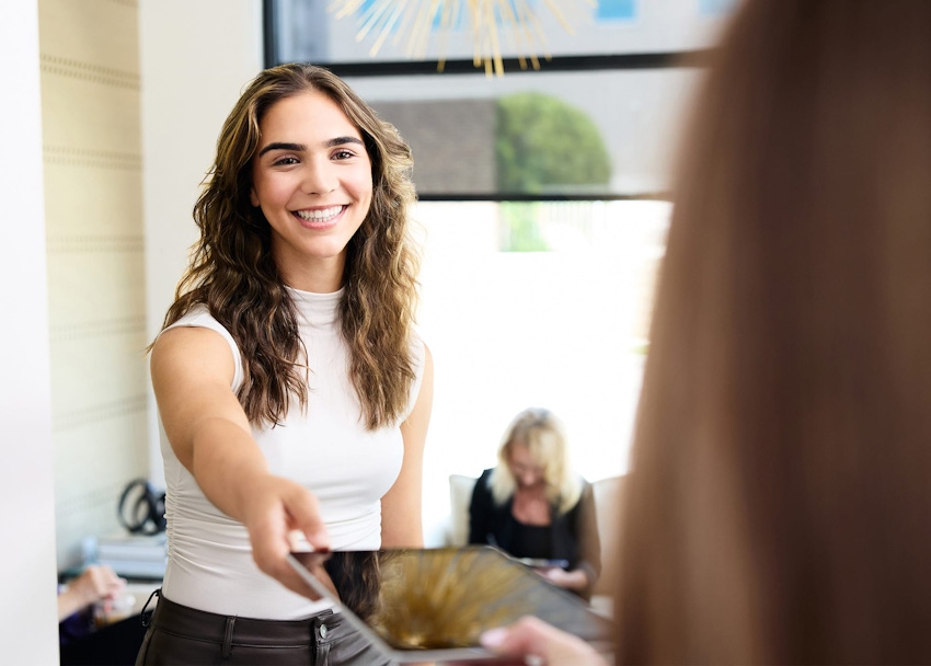 Patient handing ipad to staff member