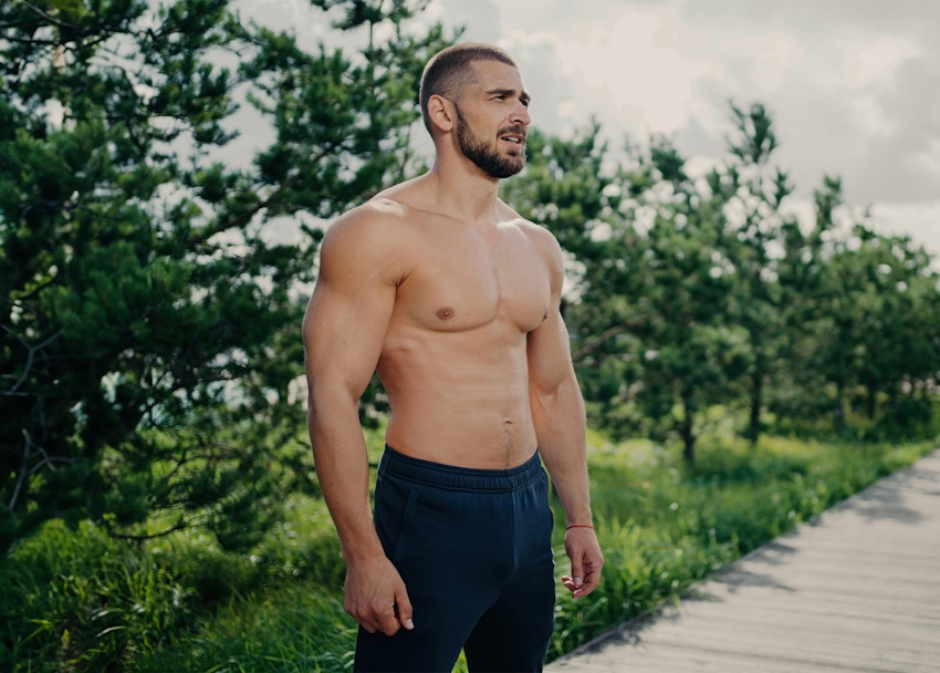 Man in ocean running hands through hair