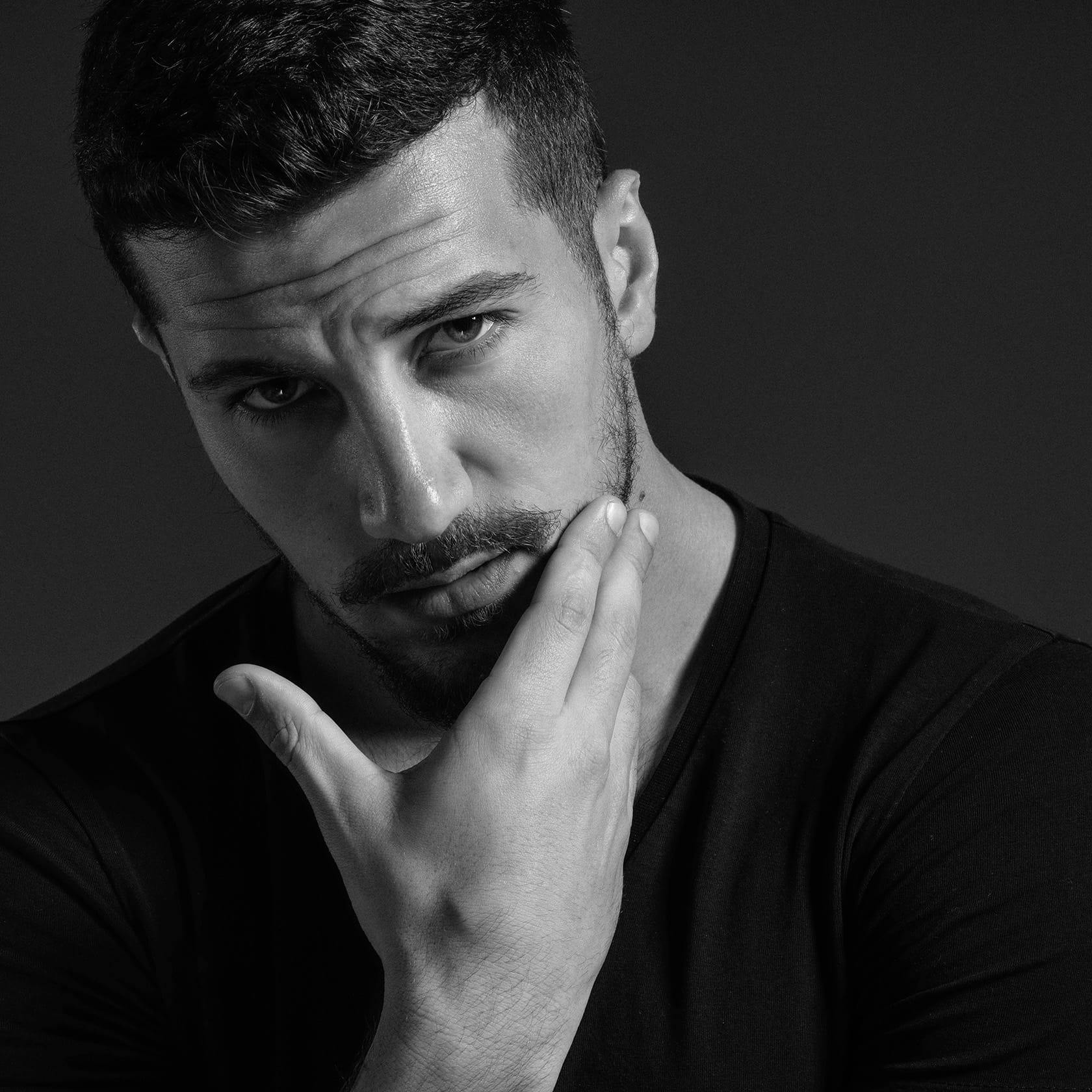 man touching his face