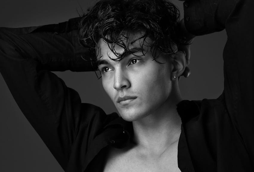 man holding his hands above his head