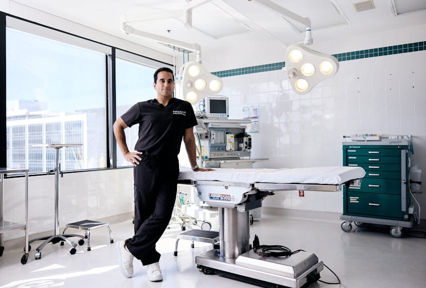 Dr. Dugar leaning against an operating table