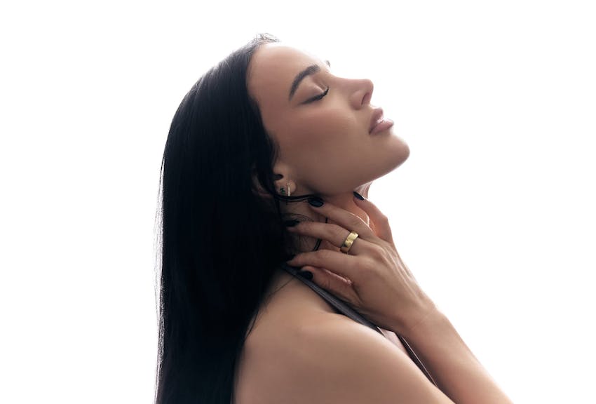 woman holding her neck, leaning her head back with her eyes closed